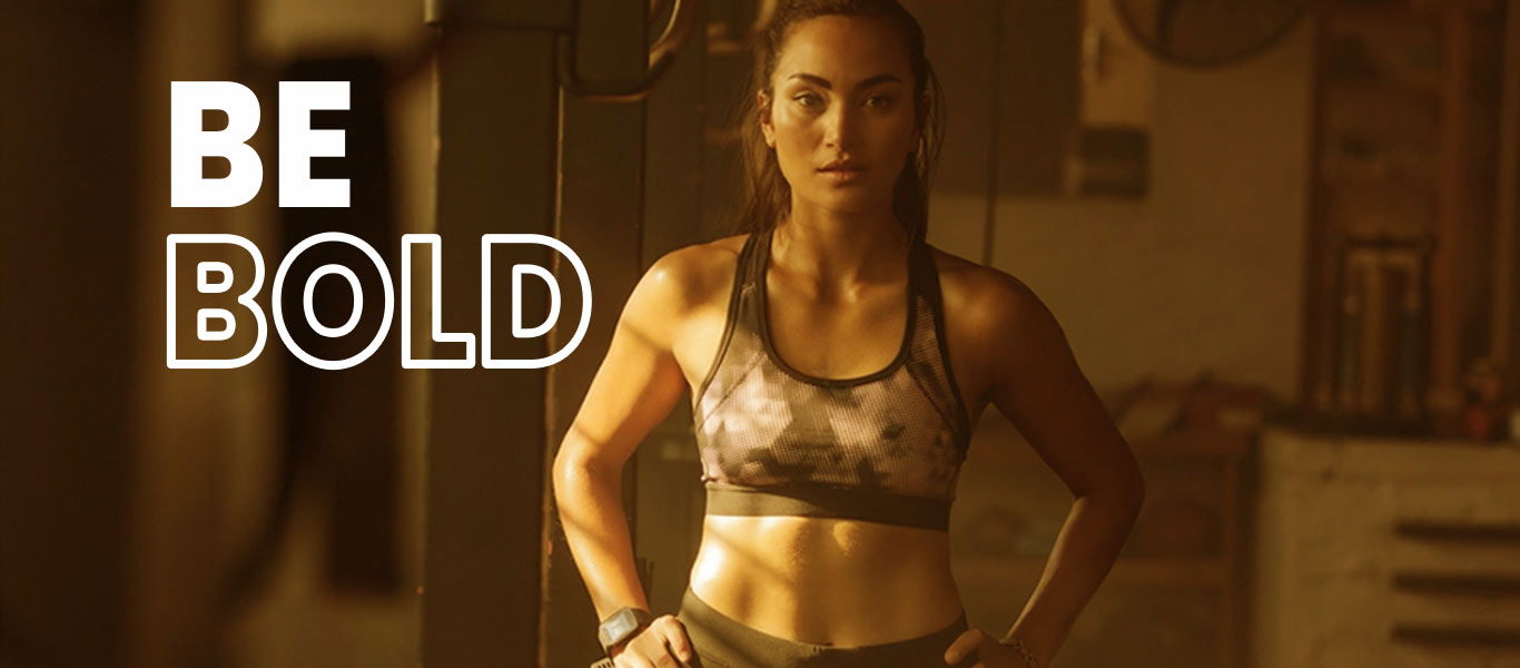 Image of a bold woman who has chiseled her own personality with the help of the supporting and motivating trainer in gym.